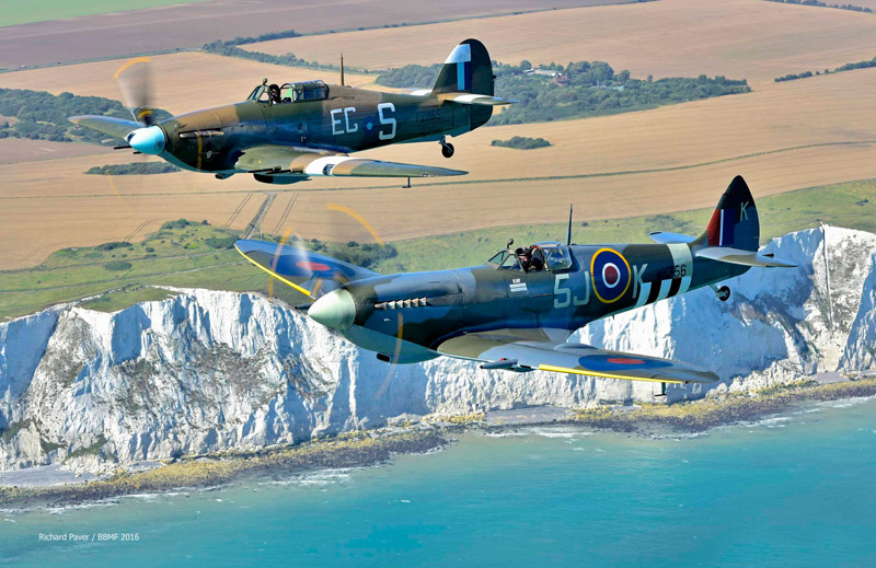 BBMF Spitfire Mk L.F. IXe MK356 and Hurricane Mk IIC PZ865 fly past the white cliffs near Eastbourne, the aircraft and the backdrop all British icons.