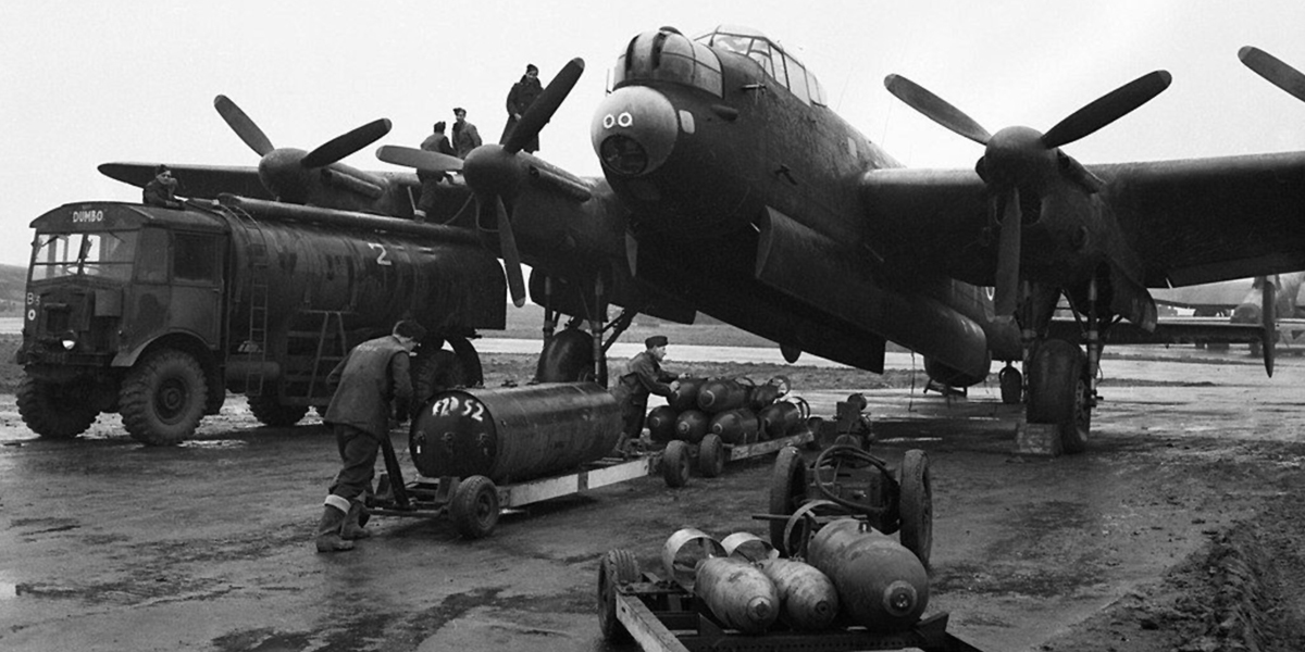 Ground crew refuelling and bombing-up a Lancaster of 75 (NZ) Sqn.